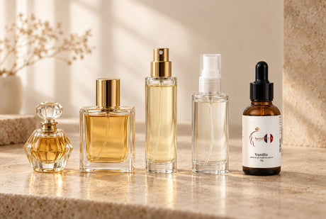 A row of fragrances from extrait to body mist, the liquid paler in each, ending with a Scent DNA Vanilla perfume oil dropper bottle
